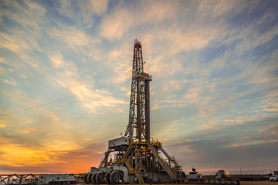 Oil drilling rig at dawn
