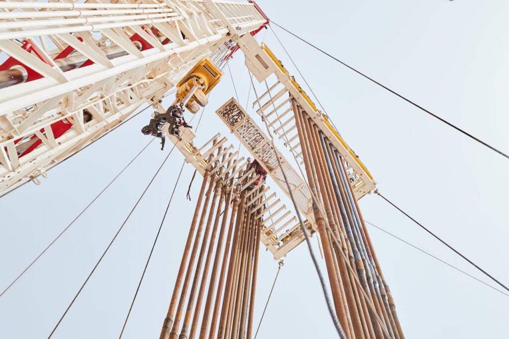 pexels-photo-13129752 Dynamic low angle view of an oil rig structure in Al Wafrah, Kuwait.